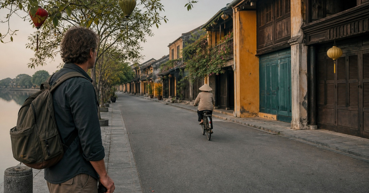 Hoi An street photography guide with a photographer observing a quiet heritage lane near the river